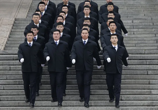 Chinese soldiers dressed as ushers march out of the Great Hall of the People during the opening session of the Chinese People's Political Consultative Conference (CPPCC) in Beijing, Thursday, March 3, 2016. The more than 2,000 members of China's top legislative advisory body convened their annual meeting Thursday, kicking off a political high season that will continue with the opening of the national congress on Saturday. (Photo by Andy Wong/AP Photo)