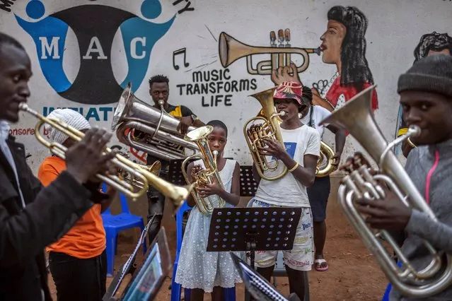 Members of a community brass band rehearse ahead of a performance at the Bwaise informal settlement in Kampala on January 23, 2024. (Photo by Luis Tato/AFP Photo)