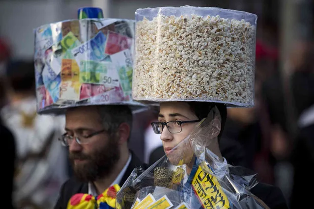 Ultra-Orthodox Jews wear costumes during the Jewish festival of Purim, in Bnei Brak, Israel, Thursday, March 21, 2019. The Jewish holiday of Purim commemorates the Jews' salvation from genocide in ancient Persia, as recounted in the Book of Esther. (Photo by Oded Balilty)/AP Photo