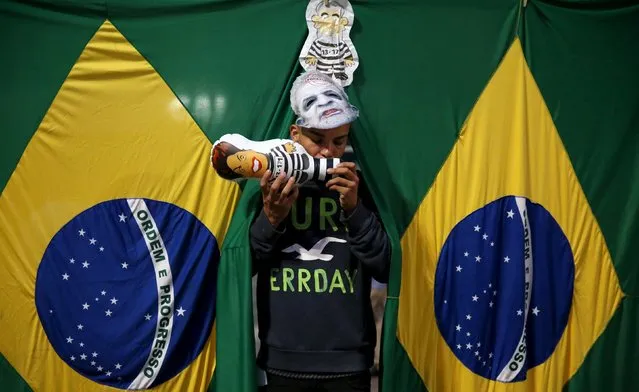 A man blows an inflatable doll, known as “Pixuleco”, of Brazil's President Dilma Rousseffa after a protest against her as part of nationwide demonstrations calling for her impeachment in Sao Paulo, Brazil, March 13, 2016. (Photo by Nacho Doce/Reuters)