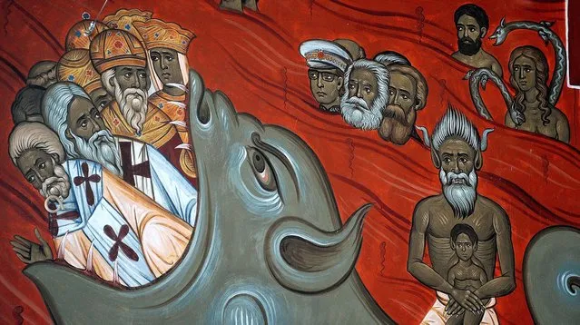 This photo taken Tuesday, February 4, 2014 shows the brightly-colored newly painted fresco in the Serbian Orthodox Church of Christ's Resurrection in Montenegro's capital Podgorica. The fresco allegedly shows late Yugoslav autocratic leader Josip Broz Tito drowning in red fiery waves of hell with Karl Marx and Friedrich Engels, authors of the 1848 Communist Manifesto. (Risto Bozovic/Associated Press)