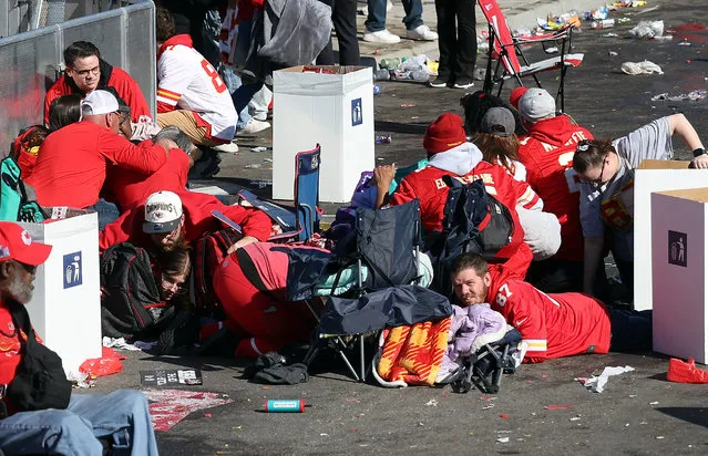 People take cover during a shooting at Union Station during the Kansas City Chiefs Super Bowl LVIII victory parade on February 14, 2024 in Kansas City, Missouri. Several people were shot and two people were detained after a rally celebrating the Chiefs Super Bowl victory.  (Photo by Jamie Squire/Getty Images)