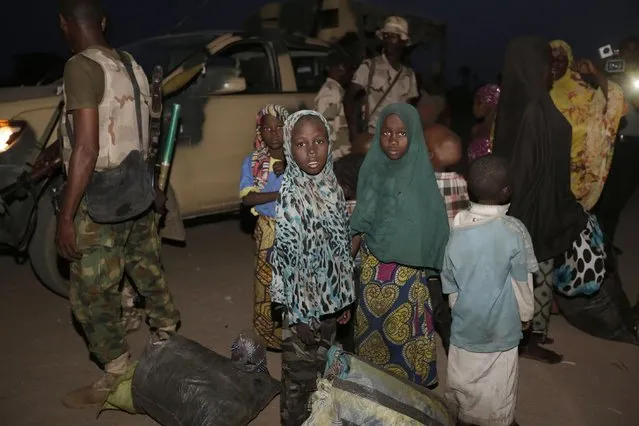 Women and children rescued by Nigeria soldiers from Islamist extremists at Sambisa forest arrive at a camp in Yola Nigeria, Saturday May. 2, 2015. The first group of nearly 300 Nigerian girls and women released from Boko Haram were brought by the military to the safety of a refugee camp in the country's northeast Saturday evening. (Photo by Sunday Alamba/AP Photo)