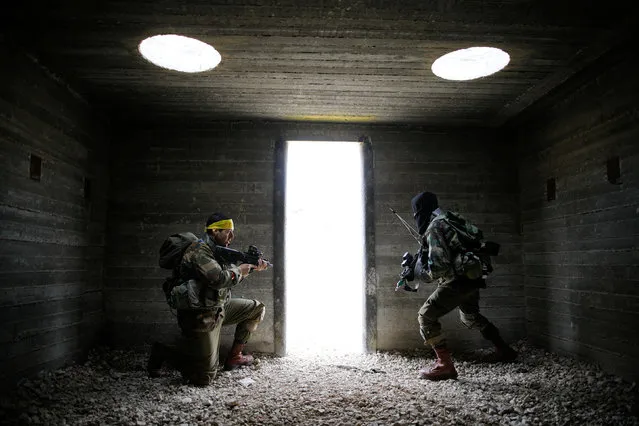 Israeli soldiers from the Nahal Infantry Brigade, one wearing a mock Hezbollah flag headband, take part in an urban warfare drill at an army base near Arad, southern Israel February 8, 2017. (Photo by Amir Cohen/Reuters)