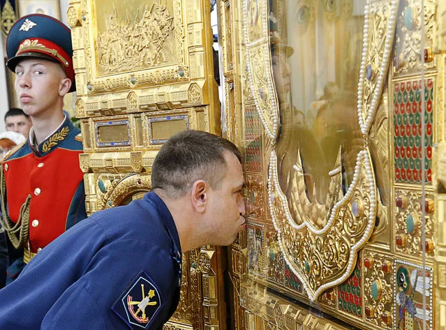 A serviceman kisses the main icon for the Russian Armed Forces' main cathedral, delivered at the Church of Our Lady the Healer in Rostov-On-Don, Russia on May 15, 2018. The Russian Armed Forces' main cathedral is to be built in Patriot Military Park in Kubinka outside Moscow by 2020, the year of the 75th anniversary of the victory of the Soviet Red Army over Nazi Germany in the 1941-45 Great Patriotic War, the Eastern Front of World War II. (Photo by Valery Matytsin/TASS)