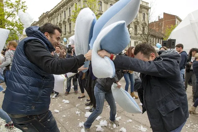 Citizens fight with pillows during the International Pillow Fight Day in Zagreb, Croatia, 02 April 2016. The Pillow Fight Day attracts tens of thousands people in more than 100 cities all over the world each year. The Croatian capital Zagreb joined this event for the first time. (Photo by Antonio Bat/EPA)