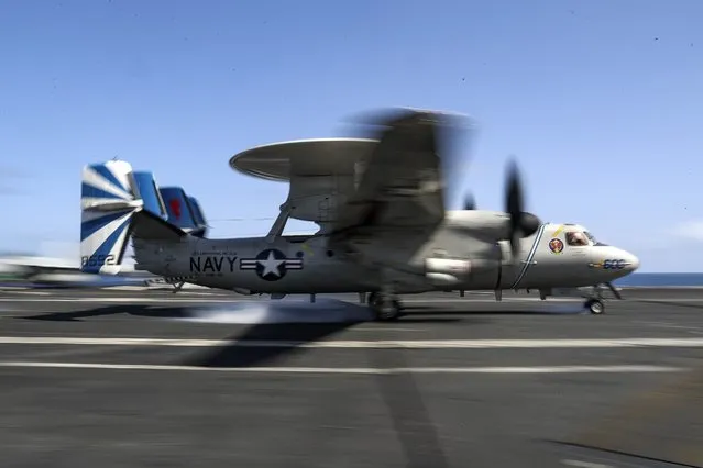 In this Monday, May 20, 2019 photo, released by U.S. Navy, an E-2D Hawkeye from the “Bluetails” of Carrier Airborne Early Warning Squadron (VAW) 121 lands on the flight deck of the Nimitz-class aircraft carrier USS Abraham Lincoln (CVN 72) on Arabian Sea. (Photo by Mass Communication Specialist 3rd Class Jeff Sherman/U.S. Navy via AP Photo)