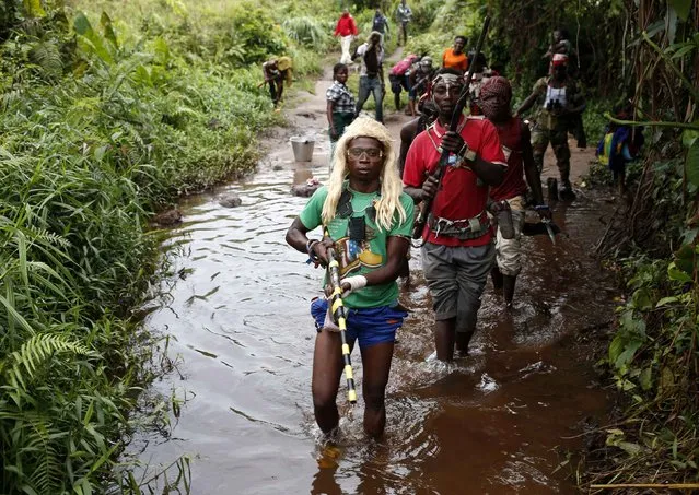 Members of the anti-balaka, a Christian militia, patrol outside the village of Zawa April 8, 2014. (Photo by Goran Tomasevic/Reuters)