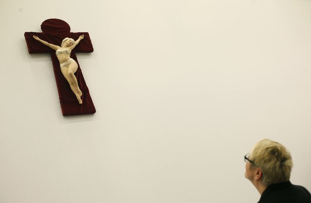 A woman looks at the artwork “Marilyn Crucifix” depicting U.S. actress Marilyn Monroe by Dutch artist Saskia de Boer at the “Art Cologne” art fair in Cologne April 9, 2014. The sculpture is on sale for 9,200 euros. Some 200 international exhibitors are taking part in the 48th Art Cologne, one of the world's leading fairs for contemporary art. (Photo by Wolfgang Rattay/Reuters)