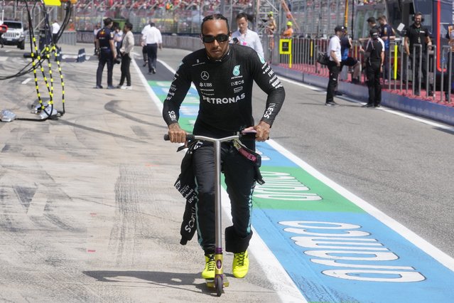 Mercedes' British driver Lewis Hamilton rides an electric scooter ahead of the Emilia Romagna Formula One Grand Prix at the Autodromo Enzo e Dino Ferrari race track in Imola on May 19, 2024. (Photo by Luca Bruno/AFP Photo)