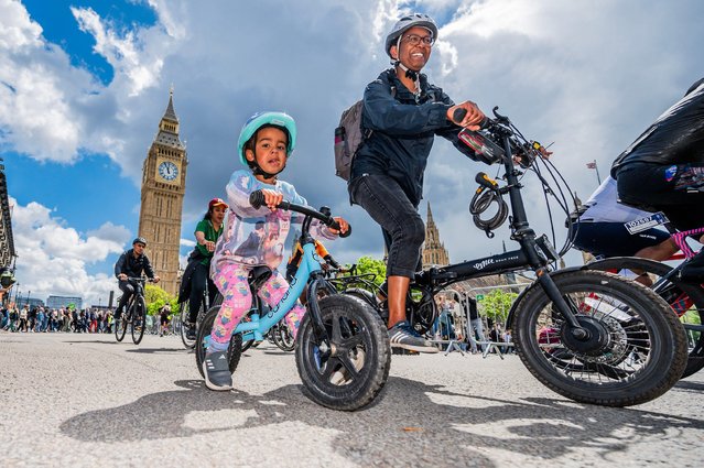 Cyclists of all ages taking part in the Ford RideLondon FreeCycle pass the Houses of Parliament in London on May 26, 2024. A seven-mile traffic free cycling course through some of London's most famous areas, open to all members of the public. (Photo by Guy Bell/Alamy Live News)