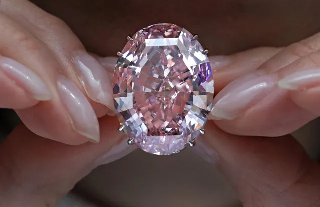 In this Wednesday, March 29, 2017, file photo, the "Pink Star" diamond, the most valuable cut diamond ever offered at auction, is displayed by a model at a Sotheby's auction room in Hong Kong. The stunning 59.6 carat diamond has sold for HK$553 million or US$71.2 million at a Sotheby's auction in Hong Kong, setting a record for any diamond or jewel. It's Also the highest price for any work ever sold at auction in Asia. (Photo by Vincent Yu/AP Photo)