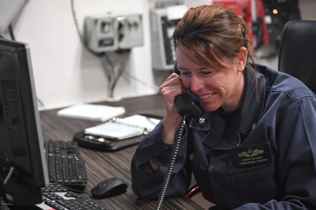 A handout photo made available by the US Navy shows Commanding Officer of guided-missile destroyer USS Porter, Andria Slough receiving a phone call from US President Donald J. Trump, onboard the USS Porter, in the Mediterranean Sea, 09 April 2017 (issued 10 April 2017). According to the US Navy, Trump called Slough in order to congratulate the commanding officers for US air strikes carried out against the regime of Syrian President Bashar al-Assad in retaliation for his alleged use of chemical weapons on 04 April. (Photo by EPA/US Navy)