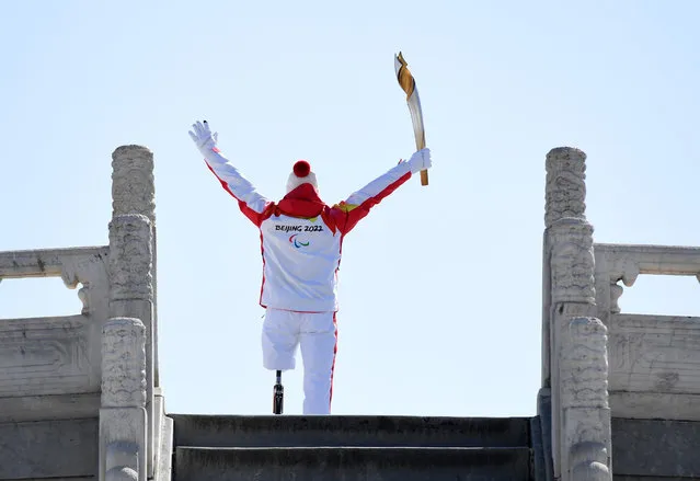 Torchbearer Hou Bin runs with his torch during the Beijing 2022 Paralymic Torch Relay and Flame Lighting Ceremony at the Temple of Heaven park in Beijing, capital of China, March 2, 2022. The flame for the Beijing 2022 Winter Paralympic Games was collected at eight locations in Beijing and Zhangjiakou. Each collection is followed by a relay of no more than 20 torchbearers on-site before the gathering of nine flames at the Temple of Heaven. (Photo by Xinhua News Agency/Rex Features/Shutterstock)