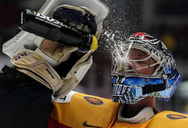 Germany goalie Timo Pielmeier refreshes himself during the Ice Hockey World Championship 2016 preliminary match between Germany and Slovakia at the Yubileiny palace in St. Petersburg, Russia, 10 May 2016. (Photo by Anatoly Maltsev/EPA)