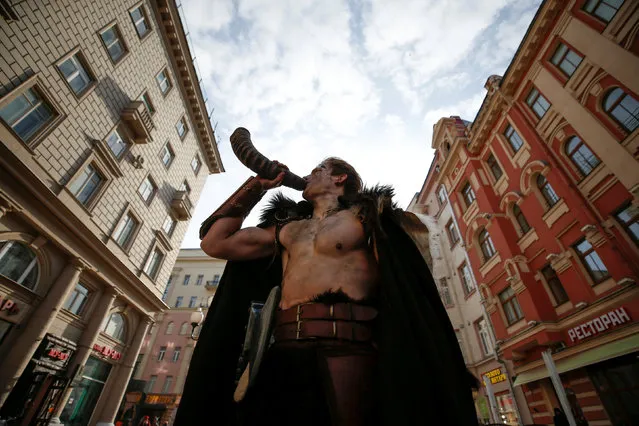 A man dressed in a Viking costume blows a horn on a street in central Moscow, Russia April 20, 2017. (Photo by Maxim Shemetov/Reuters)
