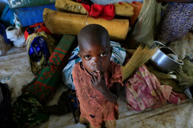A displaced boy from South Sudan stands next to family belongings in Lamwo after fleeing fighting in Pajok town across the border in northern Uganda April 5, 2017. (Photo by James Akena/Reuters)