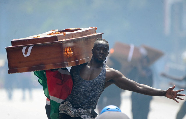 A protester carries a casket during a demonstration over police killings of people protesting against the imposition of tax hikes by the government, in Nairobi, Kenya on July 2, 2024. (Photo by Donwilson Odhiambo/Reuters)