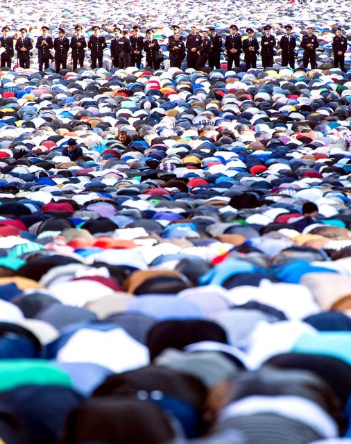 Russian Muslims pray outside the central mosque in Moscow on July 17, 2015, during celebrations of Eid al-Fitr marking the end of the fasting month of Ramadan. (Photo by Dmitry Serebryakov/AFP Photo)