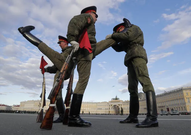 Russian honor guard soldiers warm up prior a rehearsal for the Victory Day military parade in St. Petersburg, Russia, Wednesday, May 3, 2017. The parade will take place at Dvortsovaya (Palace) Square on May 9, to celebrate 72 years after the victory in WWII. (Photo by Dmitri Lovetsky/AP Photo)