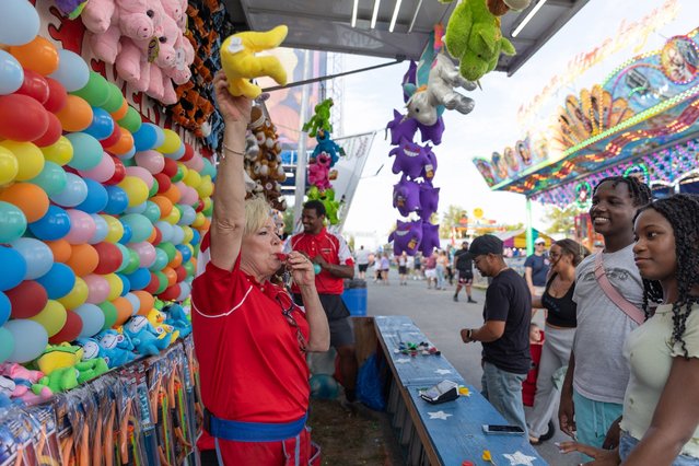 Attendees and workers are seen on opening day at the Orange County Fair in Middletown, New York, July 18, 2024. (Photo by Allyse Pulliam/The Times Herald-Record via USA TODAY Network)