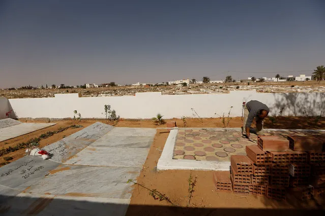 A municipal worker adds the finishing touches in Martyr's Square to a memorial to those recently killed by Islamic State's fighters in Ben Guerdane, near the Libyan border, Tunisia April 12, 2016. (Photo by Zohra Bensemra/Reuters)