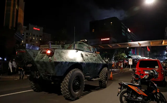 An armoured fighting vehicle (AFV) arrives near the Resorts World Manila after gunshots and explosions were heard in Pasay City, Metro Manila, Philippines June 2, 2017. (Photo by Erik De Castro/Reuters)