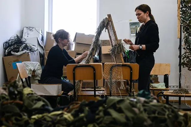 Volunteers weave ghillie suit as they continue to prepare more for the Ukrainian Army snipers in Lviv, Ukraine on May 11, 2022. According to volunteers the camouflage suits take around 3 days to complete. (Photo by Omar Marques/Anadolu Agency via Getty Images)