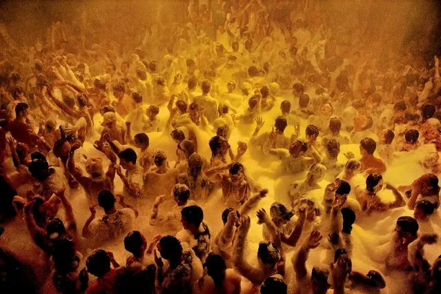 Ibiza, Spain, 1991. Soap suds dance party. David Alan Harvey writes: “The decisive moment can take a lot of clock time. This particular decisive moment took two weeks. The summer foam party at the club Amnesia in Ibiza only happens once per week ... I thought getting above it would be better to get the feeling of mass hedonism or like Dante’s Inferno ... In the end I shot one Kodachrome film frame that looks like this. The club lights flashed multiple colours at random and only this one had the feel and tone I wanted. Two weeks of time literally down to two seconds of opportunity. Worth it all”. (Photo by David Alan Harvey/Magnum Photos)