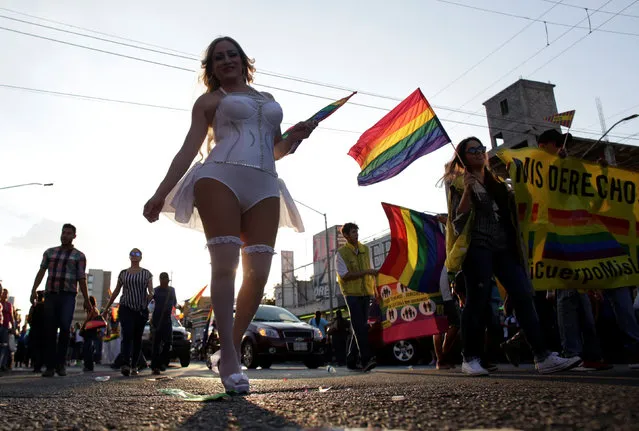 Participants hold up rainbow flags duing an annual Gay Pride Parade in Monterrey, Mexico June 18, 2016. (Photo by Daniel Becerril/Reuters)