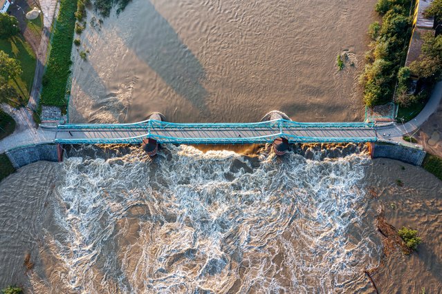 An aerial picture taken with a drone shows the surging waters of the Odra river in Wroclaw, southwestern Poland, 19 September 2024. Since 13 September, regions of Central and Eastern Europe have been severely affected by devastating floods caused by Storm Boris. On 16 September, the Polish government officially declared a state of natural disaster in the affected areas. The Polish Government has activated the State Fire Service, Volunteer Fire Service, and Polish Army, including the Territorial Defense Forces, for potential prevention and rescue efforts. (Photo by Maciej Kulczyński/EPA/EFE)