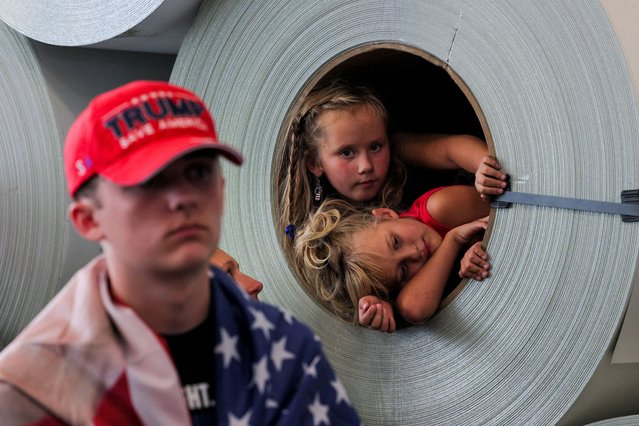 Children look on from inside a tube, as Republican presidential nominee and former U.S. President Donald Trump makes a campaign stop at manufacturer FALK Production in Walker, Michigan, U.S. September 27, 2024. (Photo by Brian Snyder/Reuters)