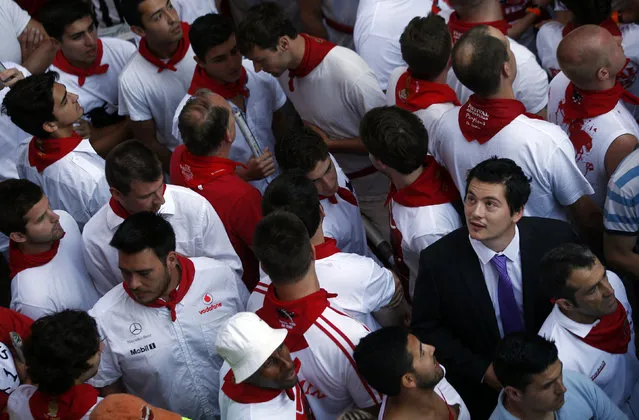 A runner dressed in suit and tie waits for the start of the second running of the bulls of the San Fermin festival in Pamplona, Spain July 8, 2013. (Photo by Susana Vera/Reuters)