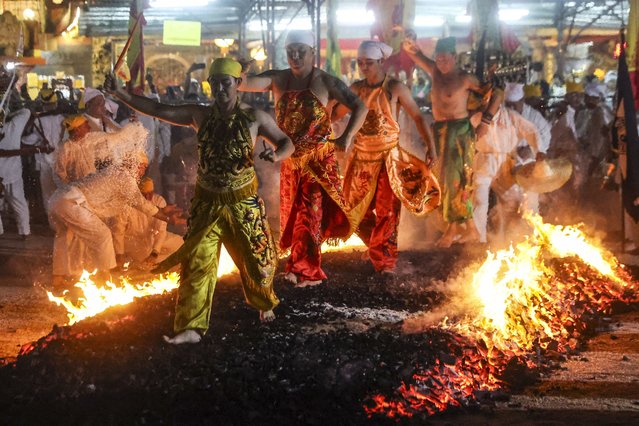 Malaysian ethnic Chinese walk on burning charcoal during the last day of the Nine Emperor Gods festival in Kuala Lumpur, Malaysia, 11 October 2024. The Nine Emperor God Festival, also known as the Vegetarian Festival, is an annual Taoist celebration held during the ninth lunar month of the Chinese calendar. During the nine-day period, worshipers will abstain from consuming meat, only consume vegetarian food, and make merit, all aimed at cleansing their body and mind. The festival is mainly celebrated in Southeast Asian countries. (Photo by Fazry Ismail/EPA/EFE)