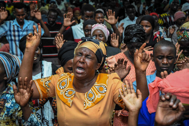 Believers immerse in prayer during a special mass held to usher in the New Year at Full Gospel Bible Fellowship church in Dar es Salaam, Tanzania, on January 1, 2020. (Photo by Ericky Boniphace/AFP Photo)