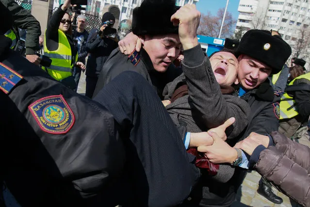 Kazakh police detain a protester in Almaty on March 1, 2020. Police in authoritarian Kazakhstan detained more than 60 people in the Central Asian country's largest city on March 1, after an activist's death in jail triggered diplomatic condemnation and calls for anti-government rallies. The protests were called after Dulat Agadil, a prominent activist, died in detention hours after he was detained by plainclothes police on Monday night. (Photo by Ruslan Pryanikov/AFP Photo)