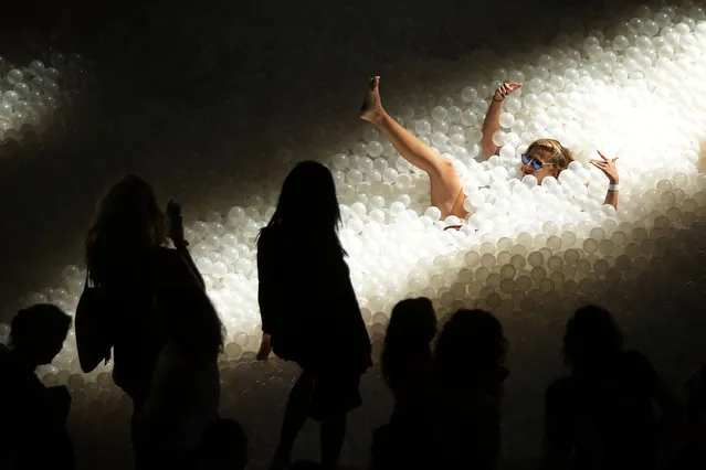 Members of the general public enjoy the “BEACH” at the National Building Museum August 25, 2015 in Washington, DC. The “BEACH” is an interactive architectural installation, with an “ocean” of nearly one million recyclable translucent plastic balls, that brings the experience of going to the beach indoor. (Photo by Alex Wong/Getty Images)