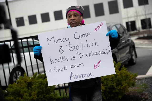 Gerald Bryson holds a sign at Amazon building during the outbreak of the coronavirus disease (COVID-19), in the Staten Island borough of New York City, U.S., March 30, 2020. (Photo by Jeenah Moon/Reuters)