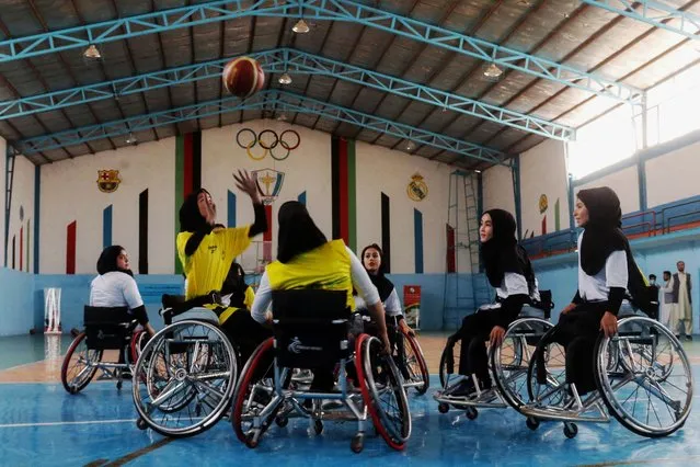 Afghan women with mobility impairment consequence of the polio disease take part in a wheelchair basketball friendly match during part of a polio vaccination campaign in Herat on August 23, 2022. (Photo by Mohsen Karimi/AFP Photo)