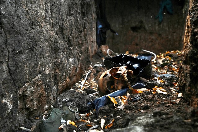 A skull of a Russian soldier is seen inside a trench at a former Russian position outside the village of Robotyne, amid Russia's attack on Ukraine, near a front line in Zaporizhzhia region, Ukraine on November 4, 2023. (Photo by Reuters/Stringer)