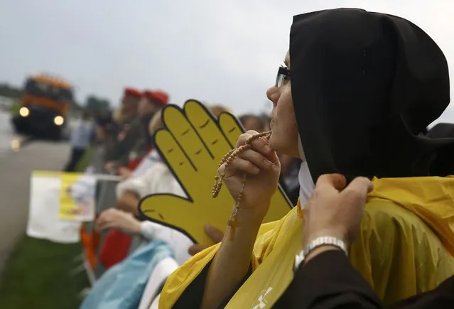 A nun holds a rosary as she waits for Pope Francis farewell ceremony at Balice airport near Krakow, Poland July 31, 2016. (Photo by Kacper Pempel/Reuters)