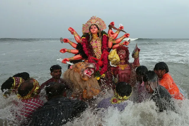 Devotees immerse an idol of the Hindu goddess Durga into the Bay of Bengal on the last day of the Durga Puja festival in Chennai, September 30, 2017. (Photo by P. Ravikumar/Reuters)