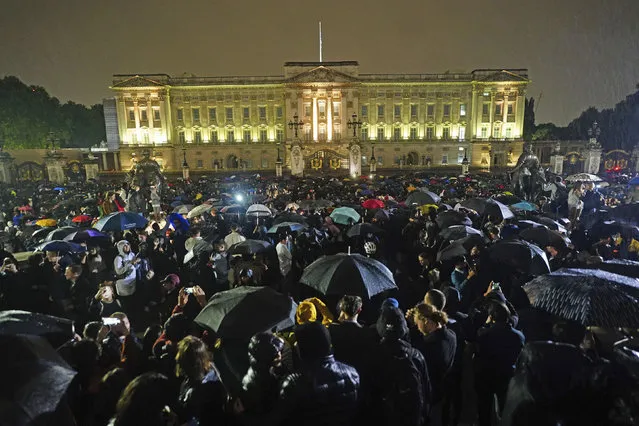 People gather outside Buckingham Palace following the announcement of the death of Queen Elizabeth II, in London, Thursday, September 8, 2022. (Photo by Victoria Jones/PA Wire via AP Photo)