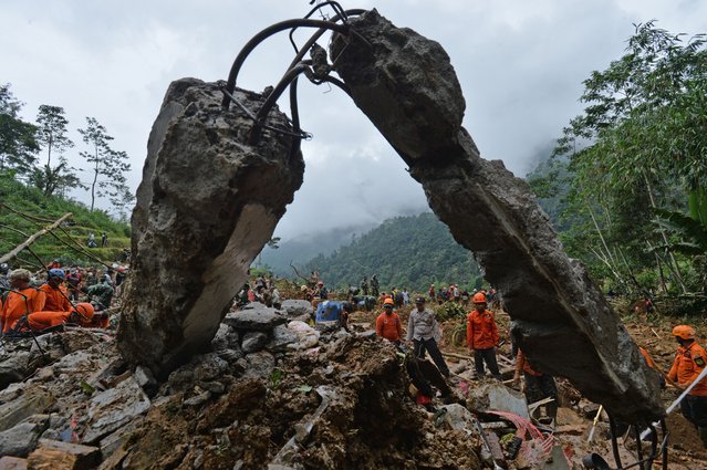 Joint officers of the National Search and Rescue Agency, Indonesian National Army, police, assisted by residents, conducted a search for victims buried by landslides in Petungkriyono, Pekalongan Regency, Central Java, on January 22, 2025. A total of 19 people were reported dead, 11 injured, 7 missing, due to flash floods and landslides, officers conducted searches by spraying water to dilute the mud that stuck to the collapsed buildings and a number of damaged vehicles. (Photo by Dasril Roszandi/Anadolu via Getty Images)