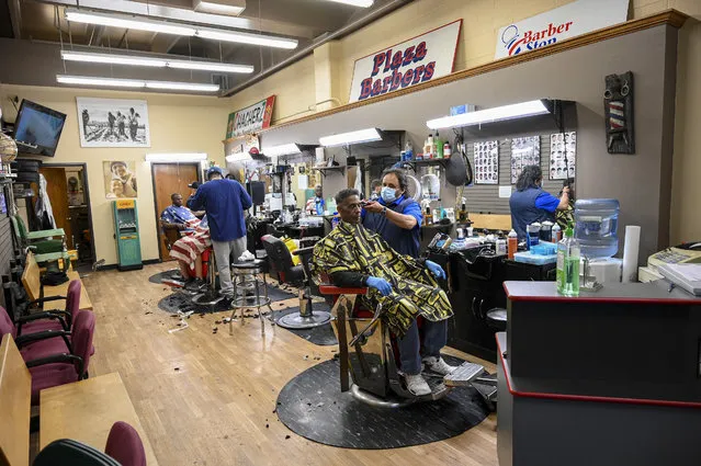 The Plaza Barber Shop in Grand Forks, ND did a steady business on Friday after reopening. North Dakota Gov. Doug Burgum announced that businesses such as restaurants, bars, and hair salons previous, closed due to the coronavirus pandemic, may reopen, with precautions, on Friday. (Photo by Russell Hons/CSM/Rex Features/Shutterstock)