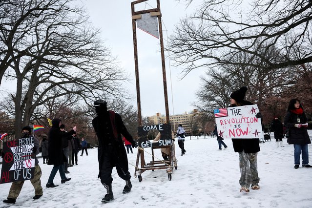A person pulls a mock guillotine, as people take part in a protest held on the day of the inauguration of Donald Trump, at Malcolm X Park in Washington. (Photo by Leah Millis/Reuters)