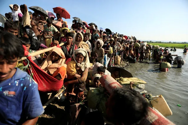 Rohingya refugees who fled from Myanmar wait to be let through by Bangladeshi border guards after crossing the border in Palang Khali, Bangladesh  October 16, 2017. (Photo by Zohra Bensemra/Reuters)