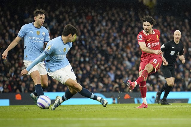 Liverpool's Dominik Szoboszlai, right, scores his side's 2nd goal during the English Premier League soccer match between Manchester City and Liverpool at Etihad stadium in Manchester, England, Sunday, February 23, 2025. (Photo by Dave Thompson/AP Photo)