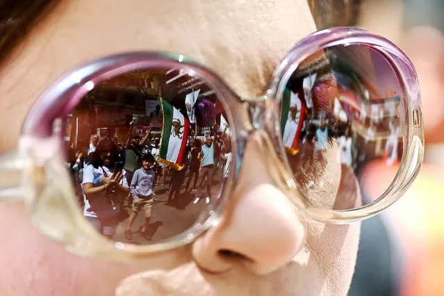 Protesters are reflected in a pair of sunglasses as they take part in a “Woman, Life, Freedom” rally for Iran women, in Sydney,  Australia, 05 November 2022. (Photo by Steven Saphore/EPA/EFE)