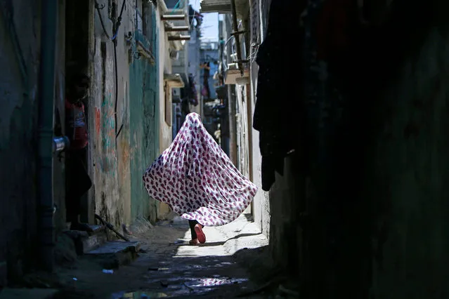 A Palestinian girl walks at the al-Shati refugee camp in Gaza City on on July 9, 2020. (Photo by Mohammed Abed/AFP Photo)